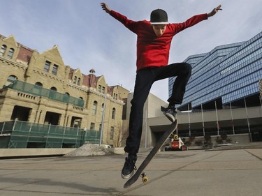 Matthew Manyheads, 17, takes advantage of this unseasonably warm January weather to skate board while waiting for the train in front of City Hall in Calgary, on January 26, 2015.