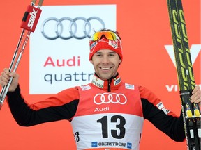 Canadian Alex Harvey celebrates the winner ceremony after the men's 15 kilometers pursuit classic style competition of the "Tour de Ski" Cross Country World Cup on January 4, 2015 in Oberstdorf, southern Germany. Norway's Petter Jr Northug won the competition, Canadian Alex Harvey placed second and Swedish Calle Halfvarsson placed third.