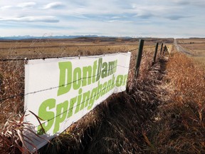 Signs supporting the DontDamnSpringbank.org movement are posted on fences along Springbank Road. The area is ground zero for the proposed Springbank Dam and Reservoir and residents are trying the fight the province's plan.