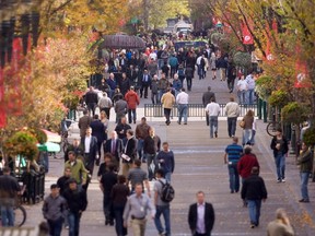 Pedestrians walk along Stephen Avenue in downtown Calgary.