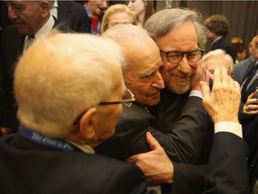 Steven Spielberg is embraced by Holocaust survivors in Krakow, Poland, where he gave a speech warning of the dangerous rise of anti-Semitism again.