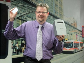 Calgary Transit director Doug Morgan with a smart card reader in 2011.