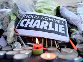 Tributes of drawings, flowers, pens and candles are left in front of the Charlie Hebdo offices on January 14, 2015 in Paris, France. Released Wednesday, an initial three million copies of the controversial magazine Charlie Hebdo were printed in the wake of last week's terrorist attacks with an additional two million copies of the magazine scheduled to be printed.