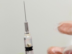 A school nurse prepares a vaccine against whooping cough.