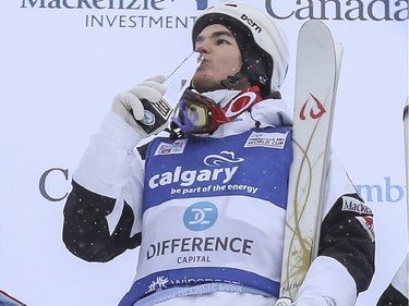 Mikael Kingsbury of Canada kisses his gold metal trophy in celebration of his first place finish at the men's Freestyle moguls skiing 2015 World Cup at Canada Olympic Park in Calgary, on January 3, 2015.