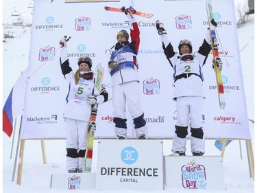 Third place finisher Justine Dufour-Lapointe, left, with her sister and second place finisher Chloe Dufour-Lapointe, right, and first place finisher, Hannah Kearney of the USA celebrate their wins at the Freestyle moguls skiing 2015 World Cup at Canada Olympic Park in Calgary, on January 3, 2015.
