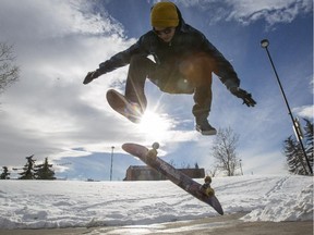 Kyle Michalski, takes advantage of the warm February day and skate boards at Millennium Park in Calgary.