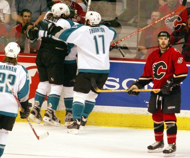 Steve Montador of the Flames looks up to the clock as the Sharks celebrate a second period goal in  Sunday's loss to San Jose May 16, 2004.