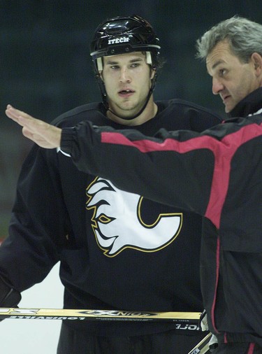 Defense Steve Montador listens to head coach Darryl Sutter at the Flames practice on September 24, 2003.
