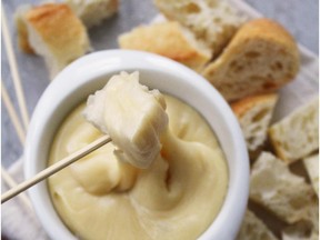 Gathering around a bubbling pot of cheese fondue is a great way to connect with friends and family.