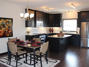 The dining nook and kitchen in the Sage show home by ReidBuilt Homes in Fireside, Cochrane.