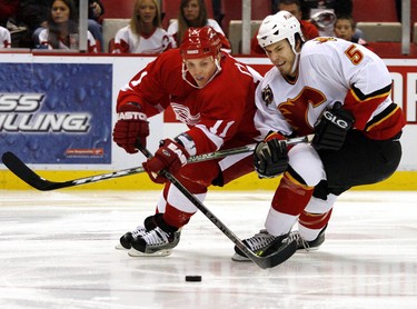 Detroit Red Wings Dan Cleary, left and Calgary Flame Steve Montador battle for the puck during second period NHL action  Sunday afternoon, Oct. 9, 2005, in Detroit.