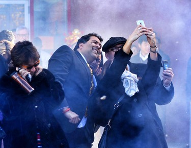 Mayor Naheed Nenshi poses for a photo as fireworks go off during Chinese New Years celebrations at the Chinese Cultural Centre on February 15, 2015.