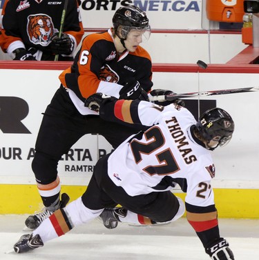 Calgary Hitmen Jordy Stallard, right, collides with Medicine Hat Tigers Matt Staples, left, during their game at the Scotiabank Saddldome on February 17, 2015.
