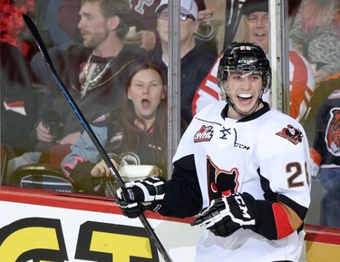 Calgary Hitmen Connor Rankin scores on Medicine Hat Tigers netminder Nick Schneider during their game at the Scotiabank Saddldome on February 17, 2015.