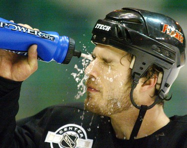 Flames defenceman Steve Montador cools down with a splash of water during a optional skate Sunday at the Saddledome. Monador is the likely replacement for Denis Gauthier, injured in Saturday's marathon overtime loss. April 18, 2004