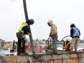 A cribbing construction crew works on the foundation of a new condo complex being built in Calgary on February 10, 2015.