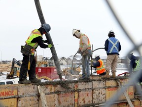 A cribbing construction crew works on the foundation of a new condo complex being built in Calgary on February 10, 2015.