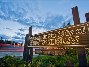 A Welcome to Fort McMurray sign stands on the side of Highway 63 on the south end of Fort McMurray, Alta. on June 19, 2013.