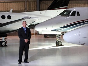 Mark Evernden, senior real estate advisor of Engel & Volkers Calgary with private jets in the hangar area, in Calgary on February 4, 2015.