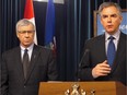 Premier Jim Prentice speaks about budget cuts as Finance Minister Robin Campbell, left, looks on in Edmonton in this file photo.