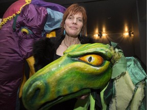 Xstine Cook, curator and director for the International Festival of Animated Objects poses for a photo with giant puppet dragon and elephant at Theatre Junction in Calgary.