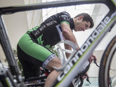 Martin Dodd, organizer of the third annual CANSuffer to Conquer event, nears the end of his 24 consecutive hour stationary bike ride to raise money for the fight against cancer at the Southcentre Mall in Calgary, on February 28, 2015.