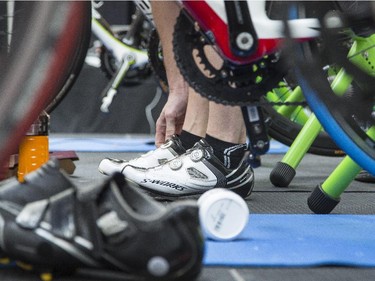 Martin Dodd, organizer of the third annual CANSuffer to Conquer event, adjusts his shoes before riding a stationary bike for 24 hours to raise money for the fight against cancer at the Southcentre Mall in Calgary, on February 28, 2015.