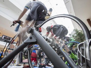 Shawn Gibbs, left, and Mike Beauchamp middle, and Martin Dodd, during the CANSuffer to Conquer event, in which participants ride for up to 24 consecutive hours to raise money for the fight against cancer at the Southcentre Mall in Calgary, on February 28, 2015.