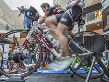 Shawn Gibbs, front legs, and Mike Beauchamp, top back, during the CANSuffer to Conquer event, in which participants ride for up to 24 consecutive hours to raise money for the fight against cancer at the Southcentre Mall in Calgary, on February 28, 2015.