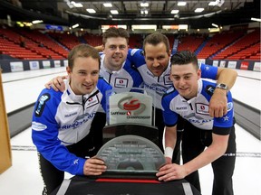 Skip Reid Carruthers, left, Braeden Moskowy, Derek Samagalski and Colin Hodgson pose with the Safeway Championship trophy after defeating Mike McEwen's rink to win the Manitoba Tankard earlier this month.