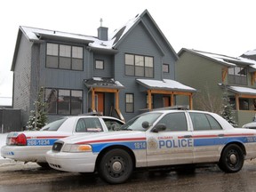 Police parked outside Kristopher (Tray) Guenther's home in the 100 block of Walden Drive S.E. in October, 2012.