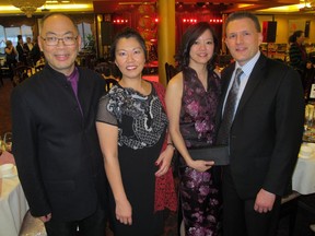 Cal 0228 Kong 2 All smiles, from left, at the Hong Kong-Canada Business Association (HKCBA) Calgary Section Chinese New Year Gala 2015 held Feb 20 at the Regency Palace Restaurant are Dialog's Robert Jim, HKCBA national chair Alexandria Sham, Calgary section president Bonita Wong and national executive director Randy Paquette. The New Year's celebration was especially meaningful for Wong and Paquette as mere hours before the gala began, Paquette proposed to Wong. She said yes.