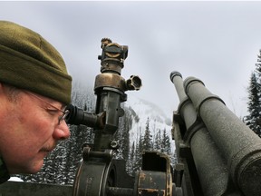 Sgt. Dave Jarrell, commander of Canadian Forces 1st Royal Canadian Horse Artillery B Battery, checks to make sure the team's 105 mm howitzer is precisely on target during a demonstration of how in conjunction with Parks Canada they use the artillery piece to control avalanches in the Rogers Pass. The control program is the world's largest mobile avalanche artillery program and has been used for 50 years to protect the Trans Canada Highway and CP Rail line from avalanches.