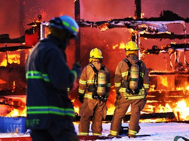 Firefighters from Calgary, Airdrie and Chestermere fought a large barn fire on an acreage northwest of Calgary on Friday evening February 27, 2015.