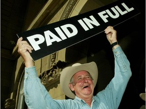 In July 2004, Alberta Premier Ralph Klein held up a Paid in Full sign after announcing that the province's debt  had been paid off.
