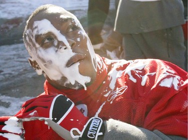 Stampeders wide receiver rookie of the year, Nik Lewis, takes on a Phantom of the Opera look after being pied by teammates at practice in October 2004.