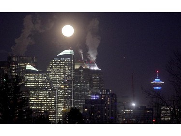 A full moon rises over downtown Calgary on Tuesday Febraury 3, 2015.