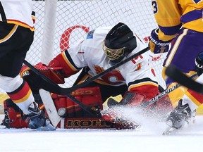 Jonas Hiller #1 of the Calgary Flames blocks a puck against the Los Angeles Kings at Staples Center on February 12, 2015 in Los Angeles, California. The Kings won 5-2.