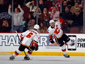Curtis Glencross, right,  celebrates his goal in the dying seconds of the second period with teammate Dennis Wideman on Wednesday night. The Flames beat the New Jersey Devils 3-1.