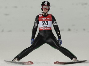 Canada's Taylor Henrich stops after her jump   during the Women's Ski Jumping competition at the Nordic Skiing World Championships in Falun, Sweden, Friday, Feb. 20, 2015.