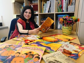 Rahat Naqvi, associate professor of language and diversity education at the U of C, promotes books with bilingual features.