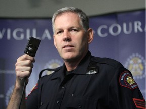 Calgary Police Sgt. Evel Kiez holds a body-worn camera that officers wear, on August 19, 2013, in Calgary.