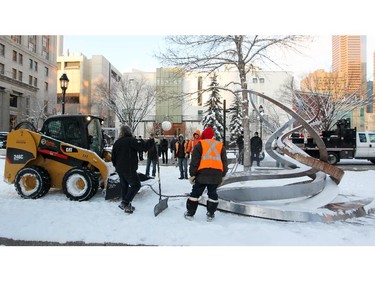 City of Calgary workers hook up the sculpture left by the Occupy Calgary protestors to a small bobcat to remove it from Calgary's Olympic Plaza on December 12, 2011.