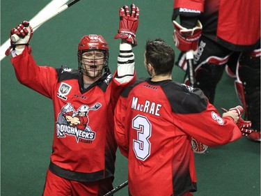 Calgary Roughnecks players Dane Dobbie, left, and Dan MacRae celebrated after posting their first win of the season against the Vancouver Stealth in National Lacrosse League action at the Scotiabank Saddledome on February 21, 2015. The Roughnecks broke their winless season with a 16-13 win over Vancouver.