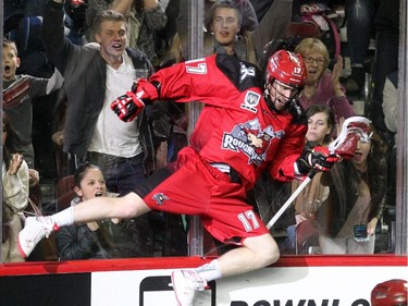 Calgary Roughnecks forward Curtis Dickson launched himself against the boards after scoring one of his seven goals on the night against the Vancouver Stealth during second half National Lacrosse League action at the Scotiabank Saddledome on February 21, 2015. The Roughnecks broke their winless season with a 16-13 win over Vancouver.