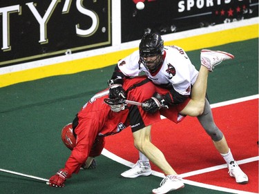 Calgary Roughnecks transition Curtis Manning and Vancouver Stealth defenceman Chris O'Dougherty got caught up with each other during first half National Lacrosse League action at the Scotiabank Saddledome on February 21, 2015.