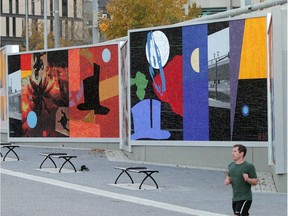 A runner jogs by mosaic artwork created by  Ron Moppett in the East Village  along Riverfront Avenue shortly before the June 2013 flood.