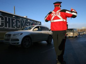 Stuart Gradon, Calgary Herald  CALGARY, AB.: DECEMBER 08, 2010 -- Calgary police start conducting enhanced daytime Check Stops throughout the holiday season on Bow Trail, in Calgary, Alberta Wednesday, December 8, 2010. (Stuart Gradon/Calgary Herald)  (For City story by None) 00030876A