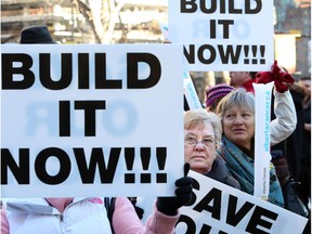 Protesters rally against delays to building the new Tom Baker Cancer Centre. Reader says a lack of facilities is causing patients to suffer.